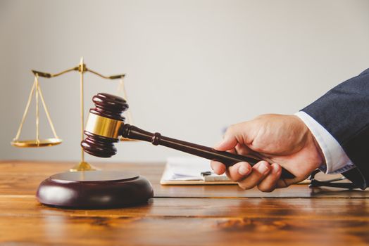 Law theme, mallet of the judge, law enforcement officers, evidence-based cases, and documents taken into account.
