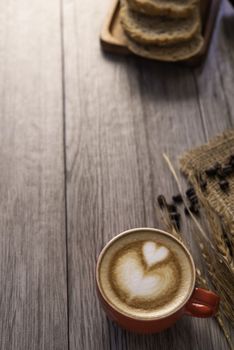 Red coffee glass rests on wood floor. concept still life