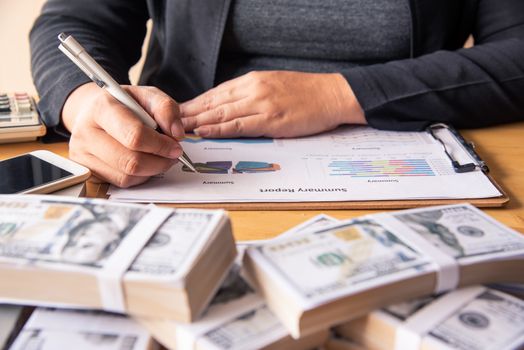 Businessmen are working on dollars, calculating profits and earning results, 