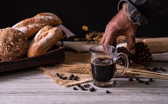 Barista's hands are delivering coffee to customers.