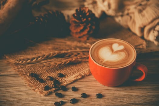 Red coffee glass rests on wood floor. concept still life