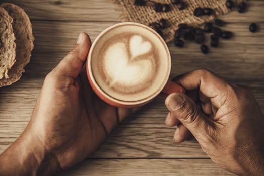 Hand is holding a red cup of coffee. concept still life
