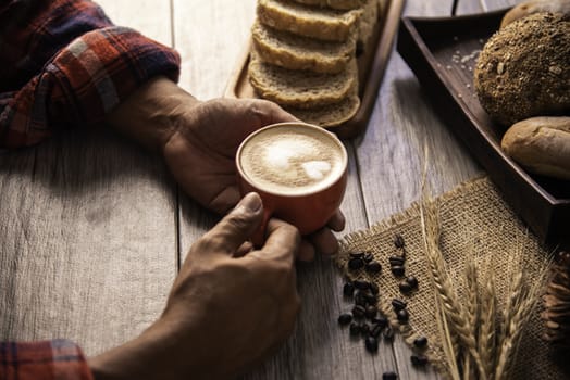Hand is holding a red cup of coffee. concept still life
