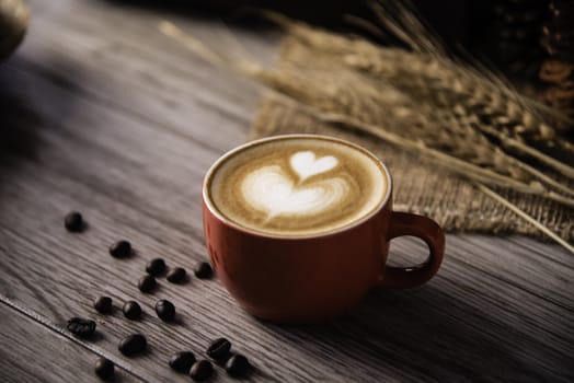 Red coffee glass rests on wood floor. concept still life