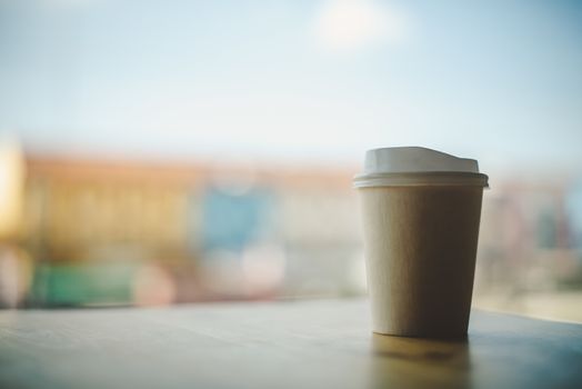 Coffee cup paper, background sky and city