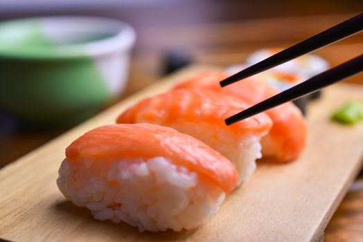 To eat sushi using chopsticks.