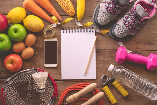fitness concept with Exercise Equipment on wooden background.