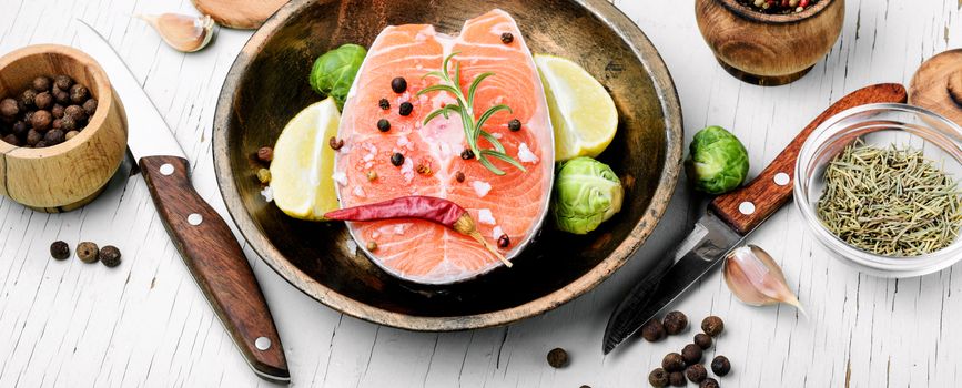 Raw salmon steak on retro background.Atlantic fish