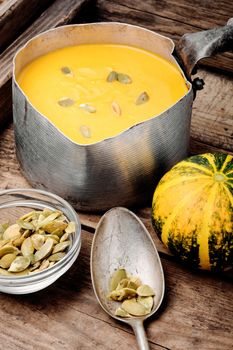 Autumn pumpkin soup in a metal saucepan. Autumn food