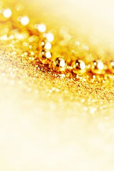Gold christmas tree garland on glitter background close-up