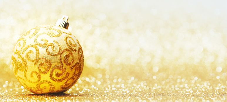 Decorative christmas ball on golden background
