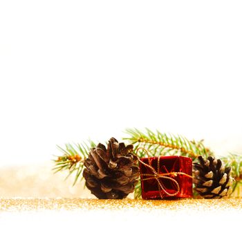 Christmas card with fir branch and decorations on golden gitter background