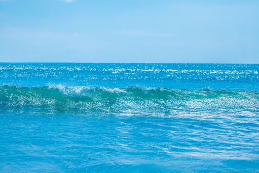 Blue tropical sea waves and clear sky background