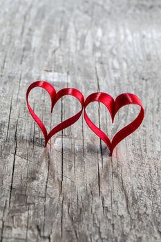 Two red ribbon hearts on wooden backround, Valentine day concept