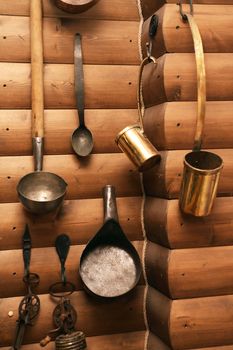 Set of old farm utensil hanging on wooden wall