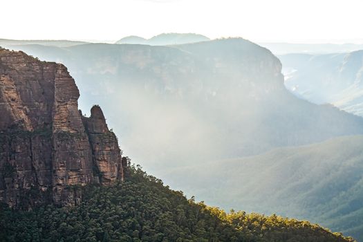 Sunlight through the valley illumnates fine mist rising up out of the Grose Valley Blue Mountains