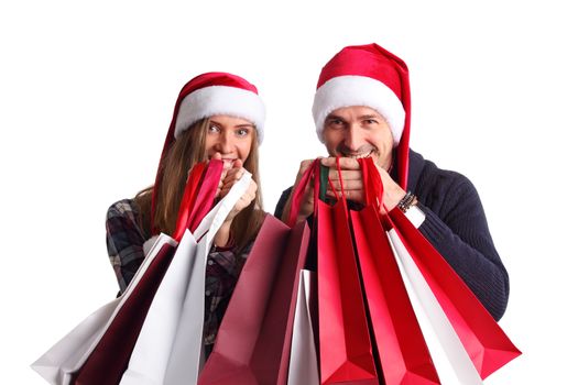 Happy beautiful couple holding many bags with christmas gifts isolated on white background