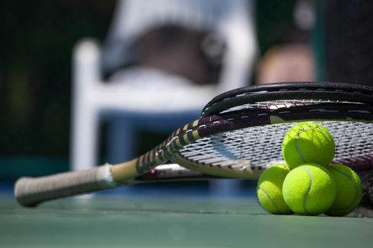 Tennis balls and racket in tennis court outdoors