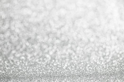 Abstract shining silver glitters bokeh background with copy space for text