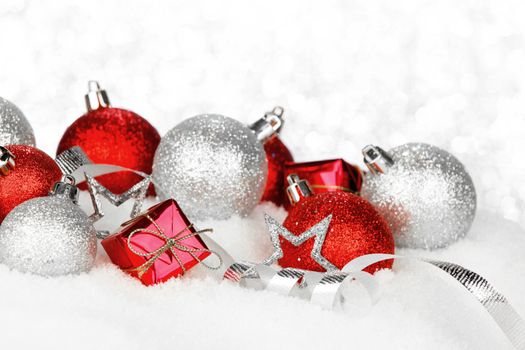 Christmas card with beautiful red and silver decorations in snow