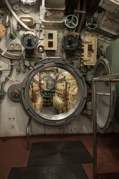 closely inside the submarine, round hatch in the engine room