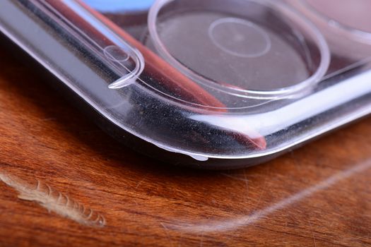 Paint pots in assorted colors. close up on wooden plate