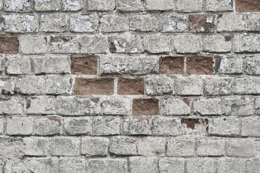 Brick wall the texture peeled with the beaten-out bricks