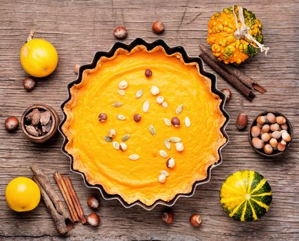 Sweet homemade thanksgiving pumpkin pie on rustic background.Thanksgiving pumpkin pies.Autumn fall still life