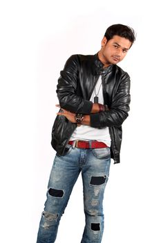 A handsome Indian teenage boy posing on a whit studio background.
