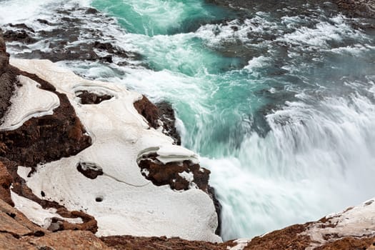 Close up of powerful Gullfoss waterfall with its green water, Iceland