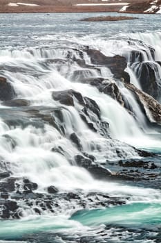 Close up of powerful Gullfoss waterfall and its green water, Iceland