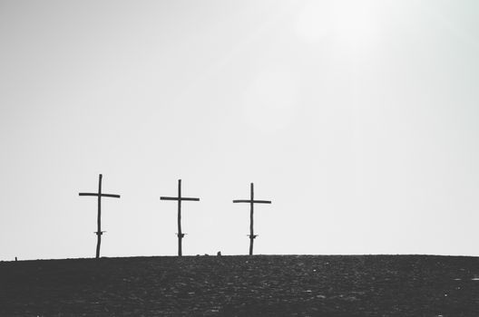 Three similar crosses on the horizont line in black and white