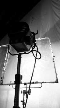 Black and white images of big studio continue LED light for video or film movie production on professional strong steel tripod and promt for shooting or set framing for director