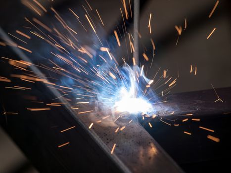 Close-up of electric welding spot producing high temperature and sparks