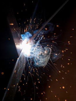 Close-up of electric welding spot producing high temperature and sparks