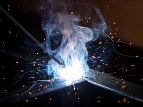 Close-up of electric welding spot producing high temperature and sparks