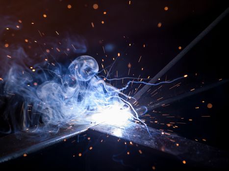 Close-up of electric welding spot producing high temperature and sparks