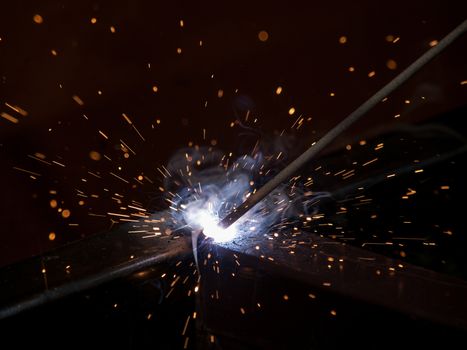 Close-up of electric welding spot producing high temperature and sparks