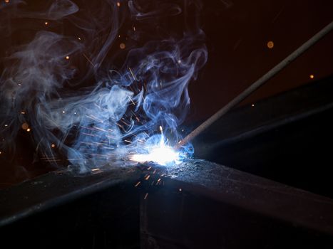 Close-up of electric welding spot producing high temperature and sparks