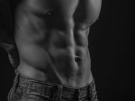 Perfectly shaped torso demonstraring abdominal muscles of a fit young man