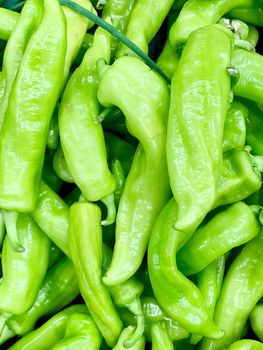 A very detailed close up of fresh green peppers. The light green colour is vivid and shining.