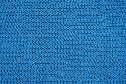 Blue knitted background of large knitting texture of knitted fabric