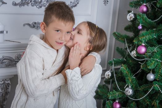 Girl whispered to her brother what to ask for Santa Claus