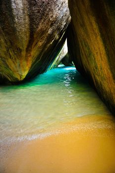 An amazing colours from yellow to turquoise of the beaches of Virgin Gorda in contrast with the blue sky and the rocks