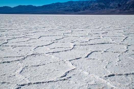 close view of the Bad Water salt field in the lowest point of North America. An impressive atmosphere in the huge valley copmpletely covered by salt. Arid climat