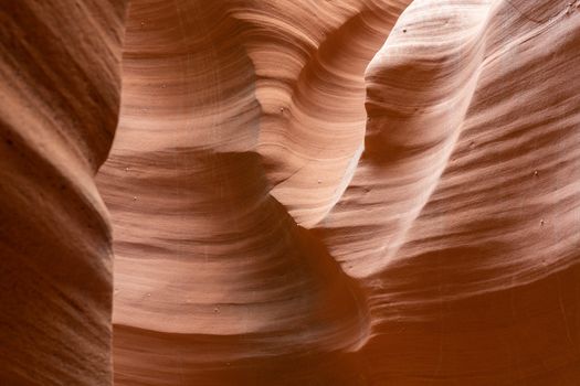 Beautiful stonesand rock formation erosed by the wind and the water. A stone stripped texture with colours that change with the sunlight from gold to red, purple, orange and blu