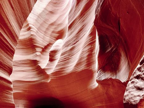 Beautiful stonesand rock formation erosed by the wind and the water. A stone stripped texture with colours that change with the sunlight from gold to red, purple, orange and blu