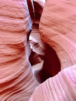 Beautiful stonesand rock formation erosed by the wind and the water. A stone stripped texture with colours that change with the sunlight from gold to red, purple, orange and blu