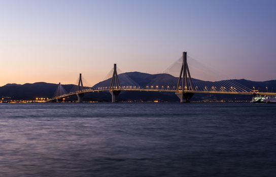 View of Rio-Antirio bridge at dusk, Greece. The Rio Antirrio Bridge is one of the world's longest multi-span cable-stayed bridges.