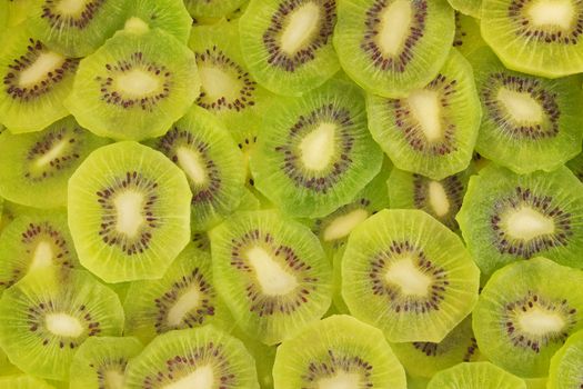 Slices of fresh kiwi fruit as an abstract texture background